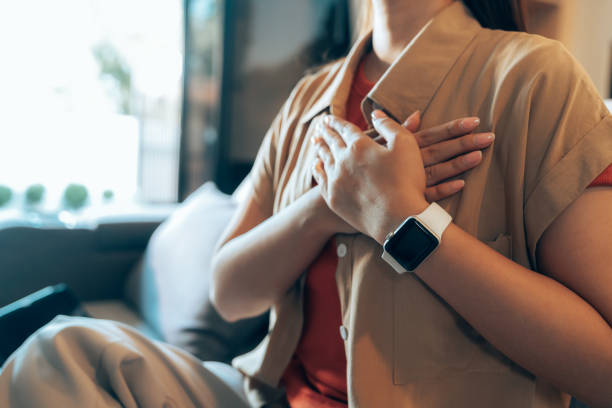 Person sitting quietly with hand on chest for body check-in
